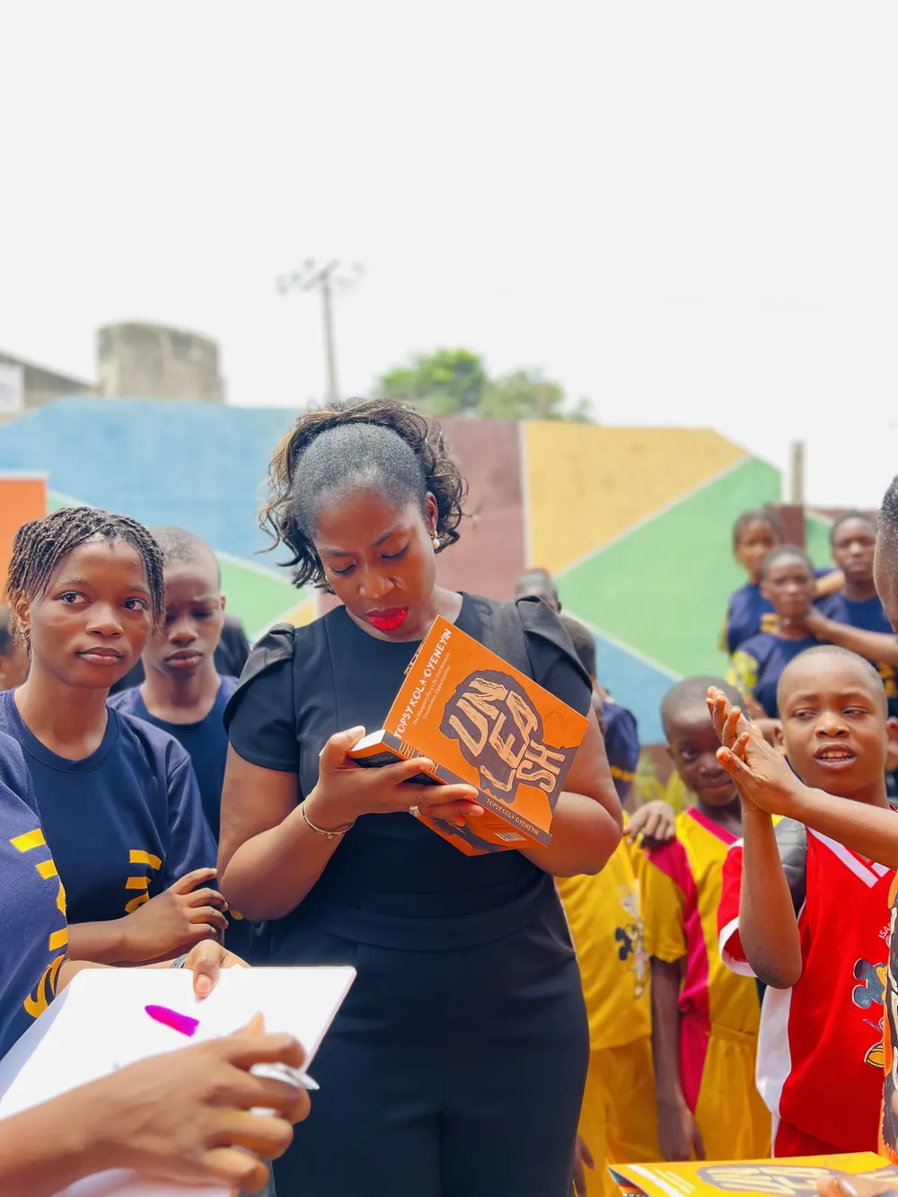 Topsy Kola-Oyeneyin signing UNLEASH for school students