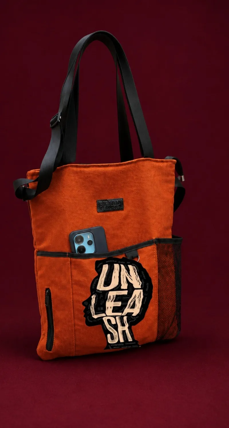 The orange Marie tote bag with the UNLEASH head